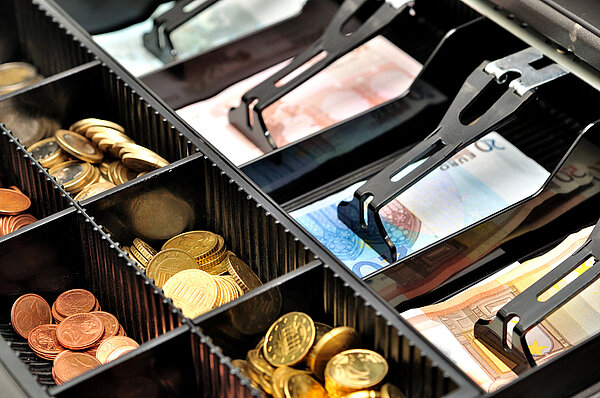 Geöffnete Kassenschublade mit Euro Bargeld